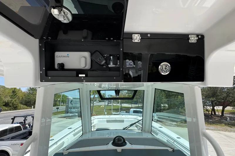 Slide: The Image of 2025 Caymas 34 CT boat helm with Garmin electronics and storage compartments. - 35
