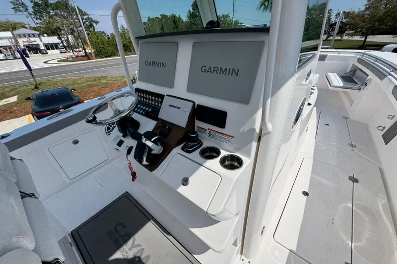 Slide: The Image of 2025 Caymas 34 CT boat helm with Garmin displays and Mercury controls. - 36