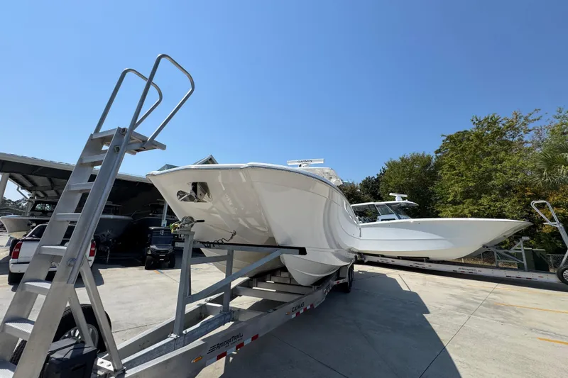 Slide: The Image of 2025 Caymas 34 CT boat on trailer under clear blue sky. - 4