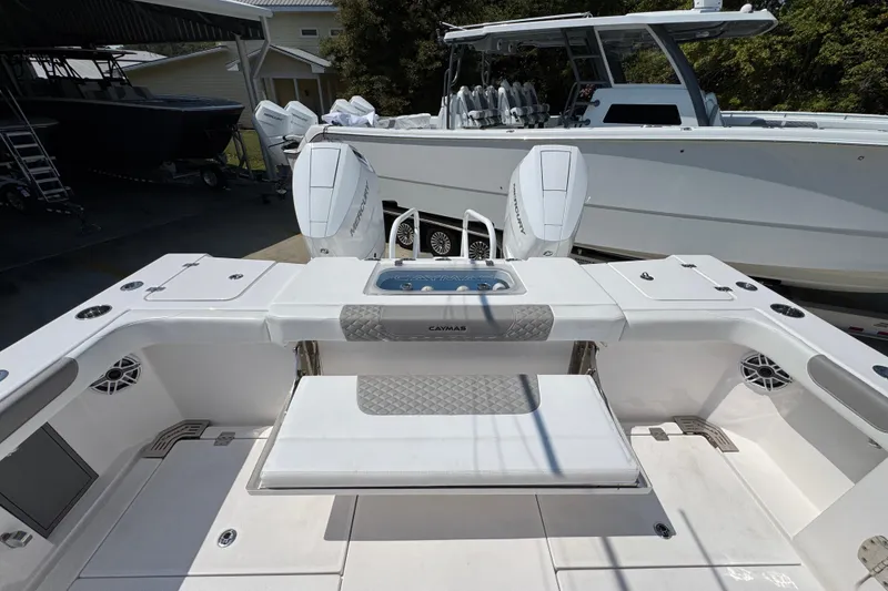 Slide: The Image of 2025 Caymas 34 CT boat interior with dual Mercury engines, spacious seating, and modern design. - 43