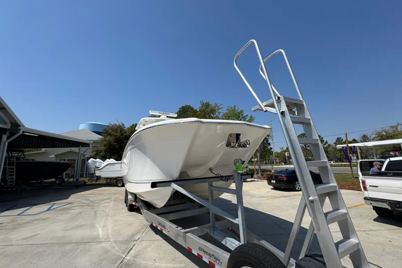 Slide: The Image of 2025 Caymas 34 CT boat on trailer under clear blue sky. - 6