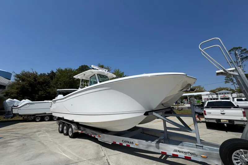 Slide: The Image of 2025 Caymas 34 CT boat on trailer under clear blue sky. - 7