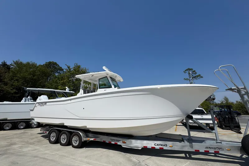 Slide: The Image of 2025 Caymas 34 CT boat on trailer under clear blue sky. - 8