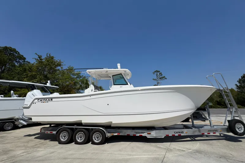 Slide: The Image of 2025 Caymas 34 CT boat on trailer, parked outdoors under clear blue sky. - 9