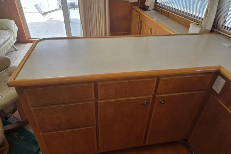Slide: The Image of Wooden kitchen counter with cabinets in a 1994 Navigator 5600 boat interior. - 11