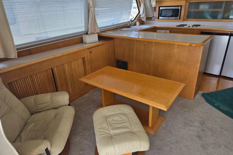 Slide: The Image of Cozy interior of a 1994 Navigator 5600 yacht with kitchen and seating area. - 12