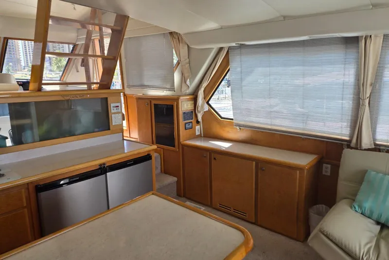 Slide: The Image of Interior of 1994 Navigator 5600 yacht with modern kitchen and seating area. - 14