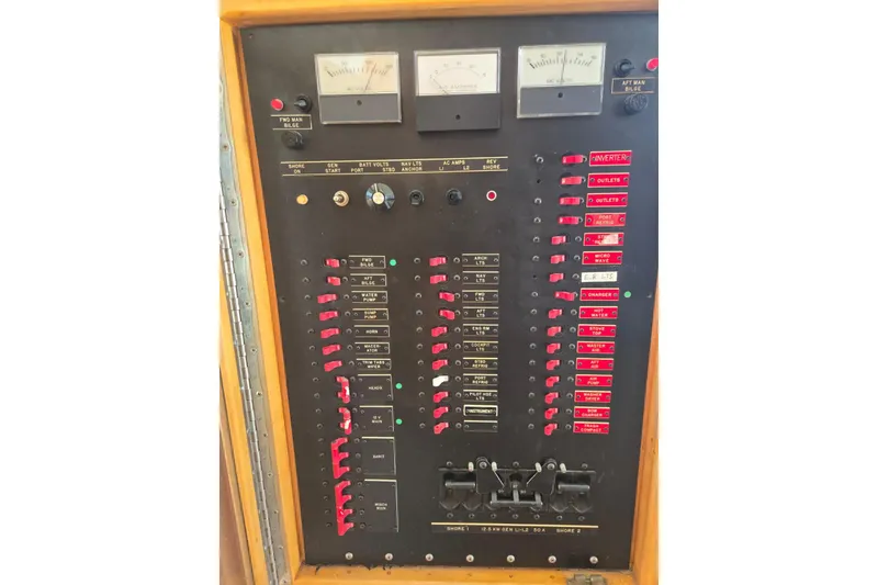 Slide: The Image of Control panel of a 1994 Navigator 5600 boat with switches and gauges. - 15