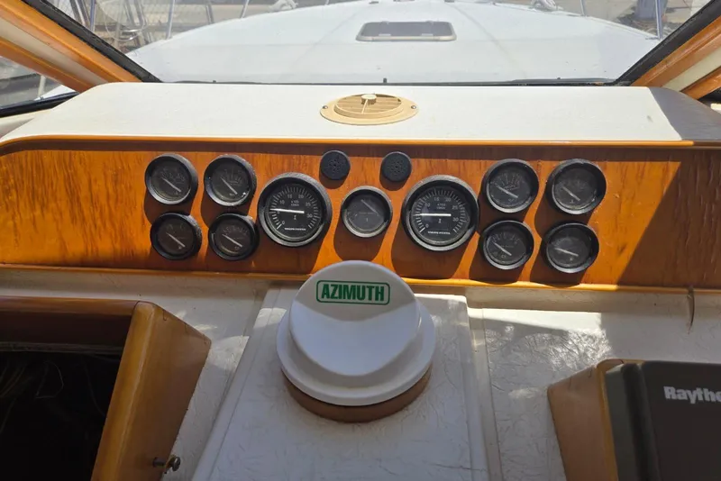 Slide: The Image of 1994 Navigator 5600 boat dashboard with gauges and Azimuth compass. - 19