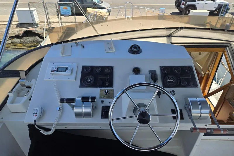 Slide: The Image of Control panel of a 1994 Navigator 5600 yacht with steering wheel and navigation instruments. - 24