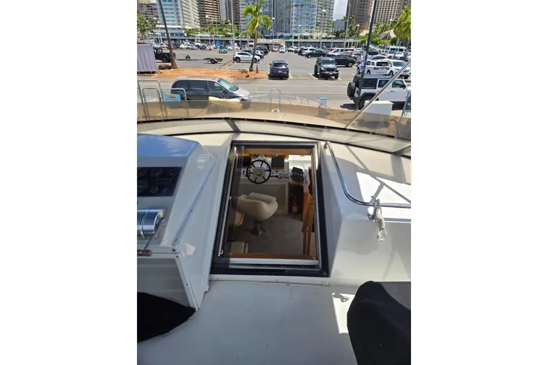 Slide: The Image of 1994 Navigator 5600 yacht interior view with steering wheel and marina background. - 25