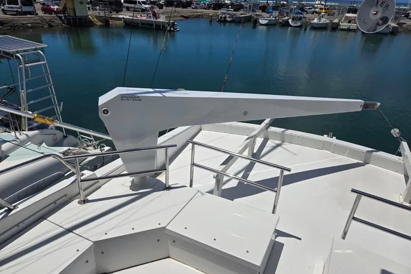 Slide: The Image of Deck of 1994 Navigator 5600 yacht with Brower Systems crane, docked at marina. - 26