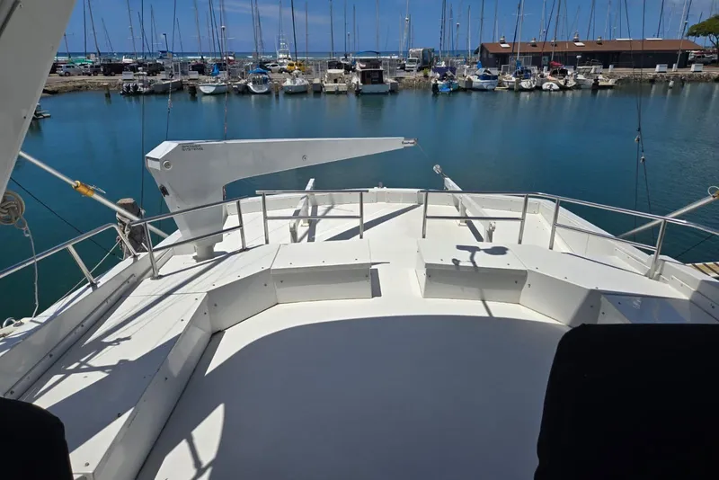 Slide: The Image of 1994 Navigator 5600 yacht deck overlooking marina with sailboats and clear blue water. - 27