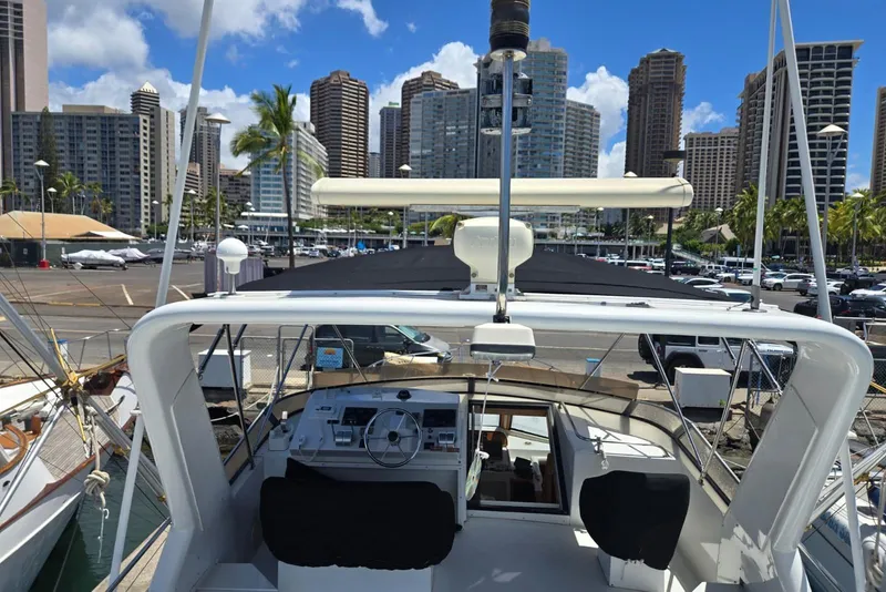 Slide: The Image of Navigator 5600 yacht docked in urban marina, city skyline in background, sunny day, 1994 model. - 28