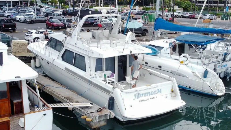 Slide: The Image of White Navigator 5600 yacht docked at marina, 1994 model, surrounded by other boats. - 3