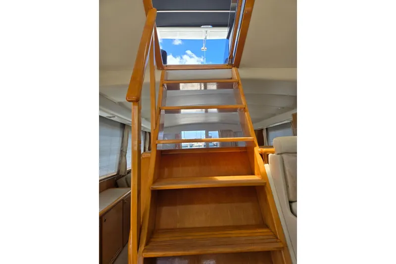 Slide: The Image of Wooden staircase inside 1994 Navigator 5600 yacht, leading to upper deck with skylight. - 30