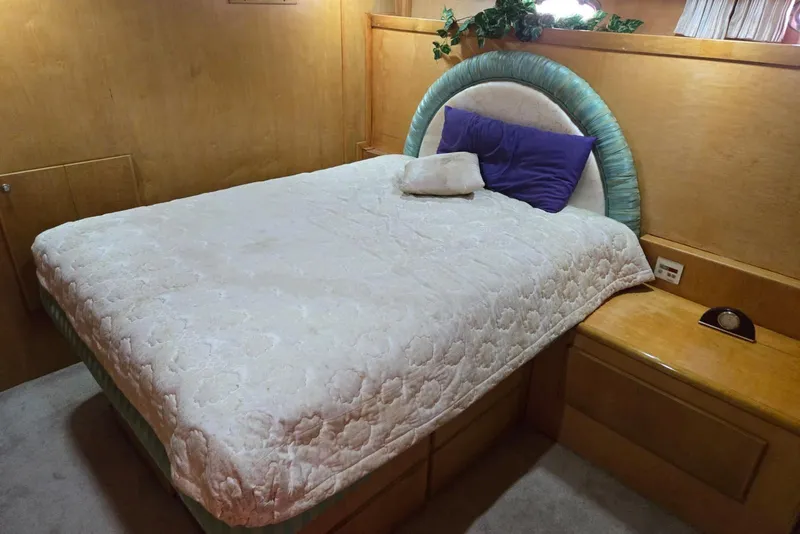 Slide: The Image of Cozy bedroom in 1994 Navigator 5600 yacht with plush bedding and wooden accents. - 31