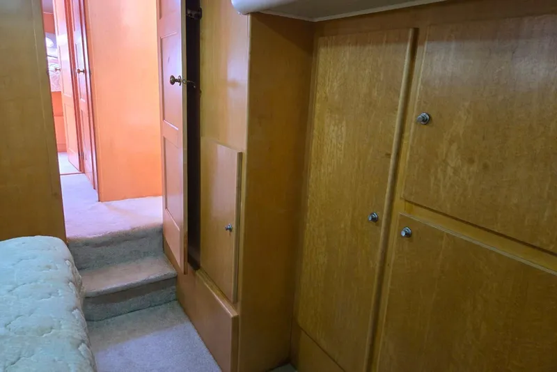 Slide: The Image of Interior of 1994 Navigator 5600 yacht with wooden cabinets and carpeted steps. - 32
