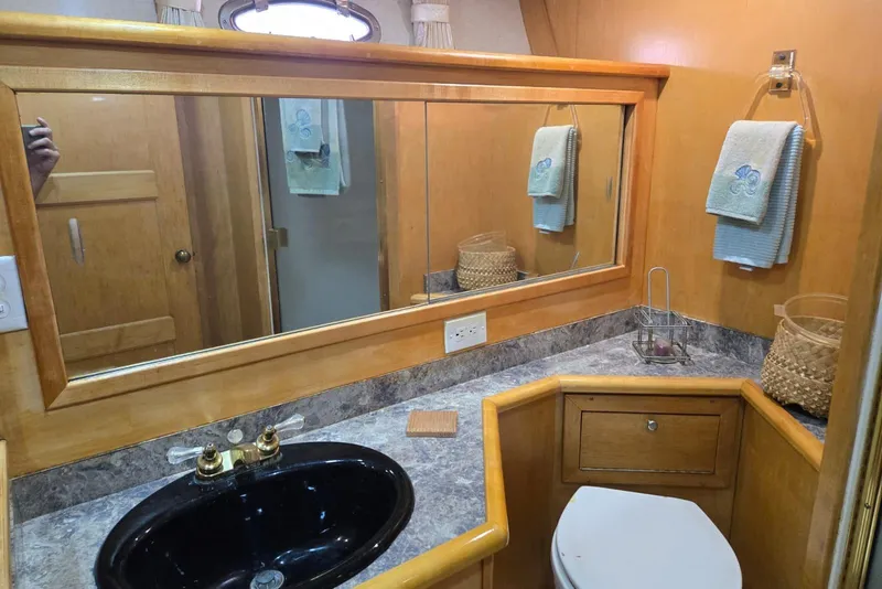 Slide: The Image of Bathroom interior of 1994 Navigator 5600 yacht with wooden cabinetry and black sink. - 33