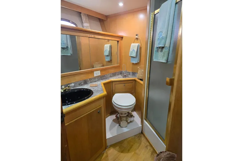 Slide: The Image of Bathroom interior of 1994 Navigator 5600 yacht with wood accents and modern fixtures. - 34