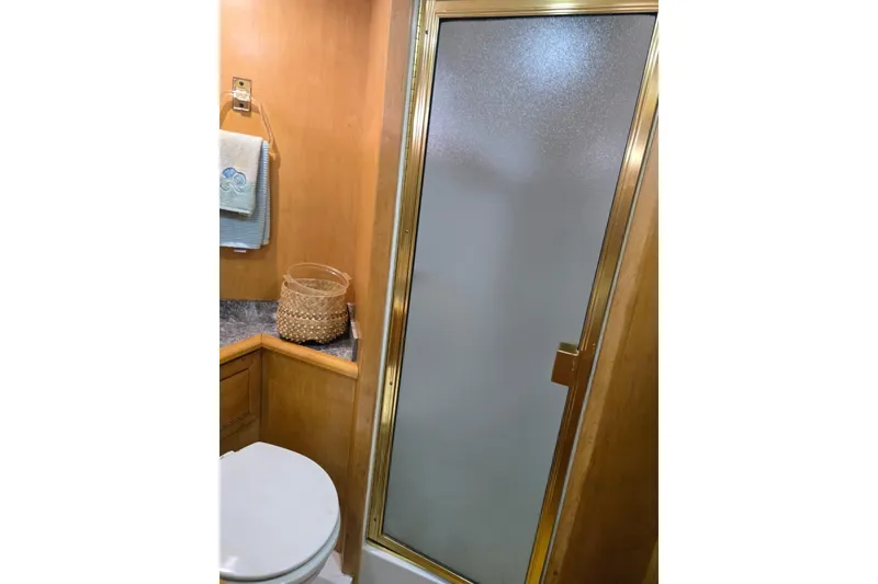 Slide: The Image of Bathroom in 1994 Navigator 5600 yacht with shower, toilet, and wooden cabinetry. - 35