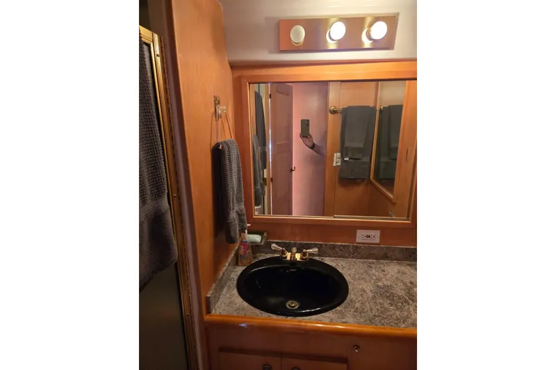 Slide: The Image of Bathroom vanity with mirror and black sink in 1994 Navigator 5600 model. - 36