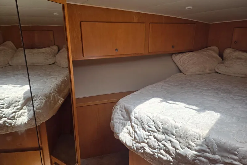 Slide: The Image of Cozy bedroom in 1994 Navigator 5600 yacht with mirrored closet and wooden cabinets. - 38