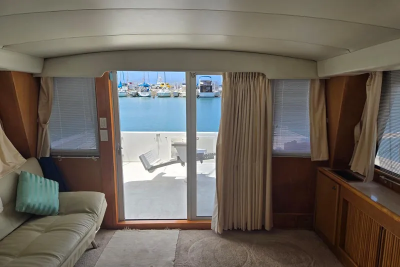 Slide: The Image of Interior view of a 1994 Navigator 5600 yacht with marina in the background. - 42
