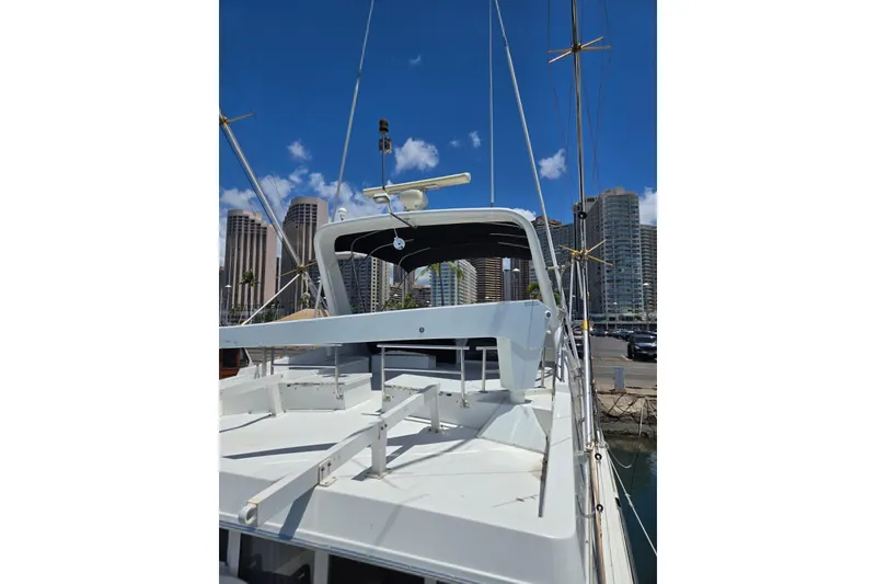 Slide: The Image of 1994 Navigator 5600 yacht docked in marina with city skyline background. - 6