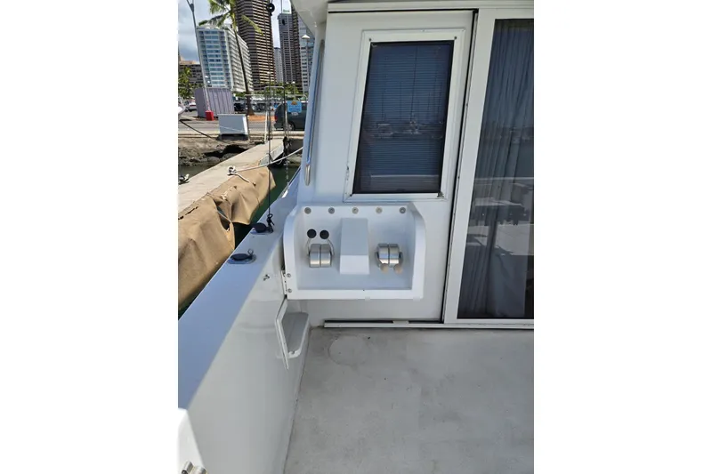 Slide: The Image of 1994 Navigator 5600 yacht deck with control panel and marina view. - 7