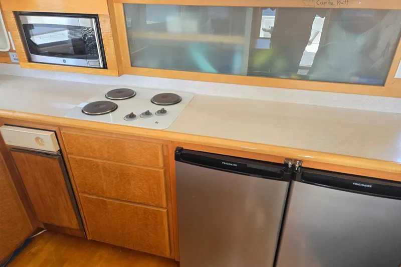 Slide: The Image of Kitchen area of a 1994 Navigator 5600 with stove, microwave, and dual Frigidaire refrigerators. - 9