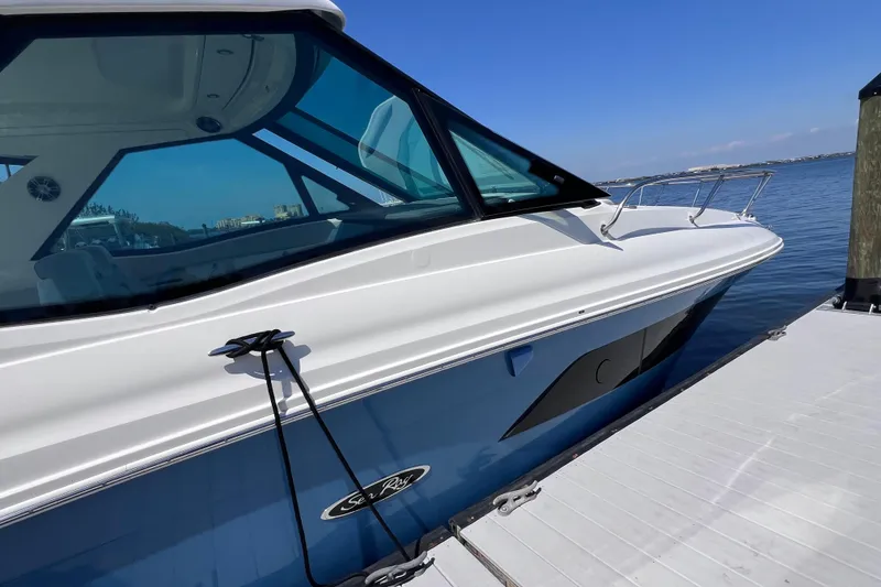 Slide: The Image of 2022 Sea Ray Sundancer 320 Coupe Outboard docked by the water. - 10