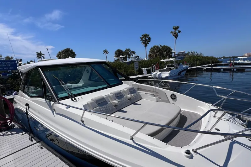 Slide: The Image of 2022 Sea Ray Sundancer 320 Coupe Outboard docked, featuring sleek design and spacious deck. - 11