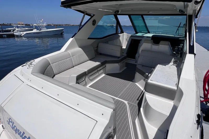 Slide: The Image of 2022 Sea Ray Sundancer 320 Coupe Outboard with spacious seating, docked on a sunny day. - 12