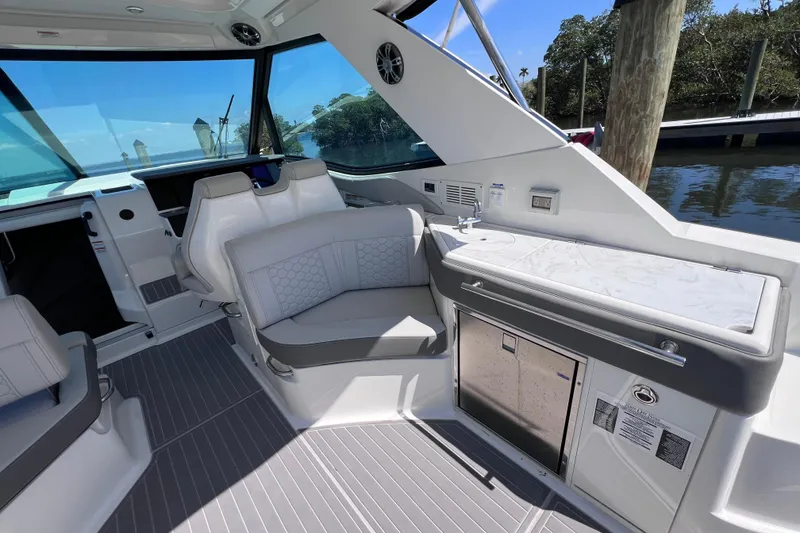 Slide: The Image of Interior of 2022 Sea Ray Sundancer 320 Coupe Outboard with seating and kitchenette. - 16