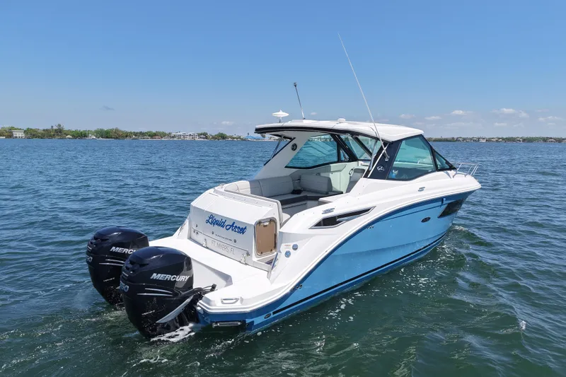 Slide: The Image of 2022 Sea Ray Sundancer 320 Coupe Outboard cruising on a sunny day. - 2