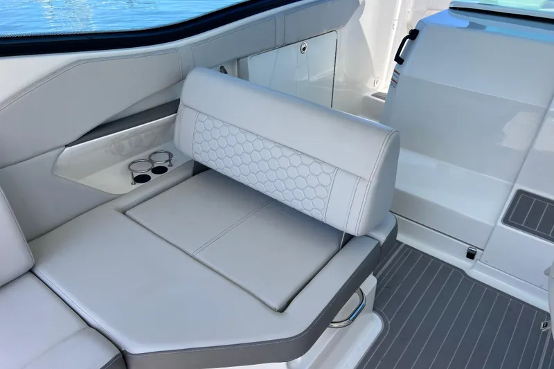 Slide: The Image of Luxurious seating on 2022 Sea Ray Sundancer 320 Coupe Outboard with cup holders and sleek design. - 22