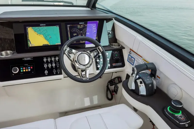 Slide: The Image of 2022 Sea Ray Sundancer 320 Coupe Outboard helm with advanced navigation displays and controls. - 23