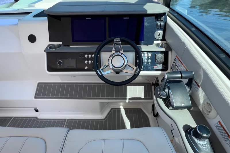 Slide: The Image of 2022 Sea Ray Sundancer 320 Coupe Outboard helm with modern controls and dual displays. - 24