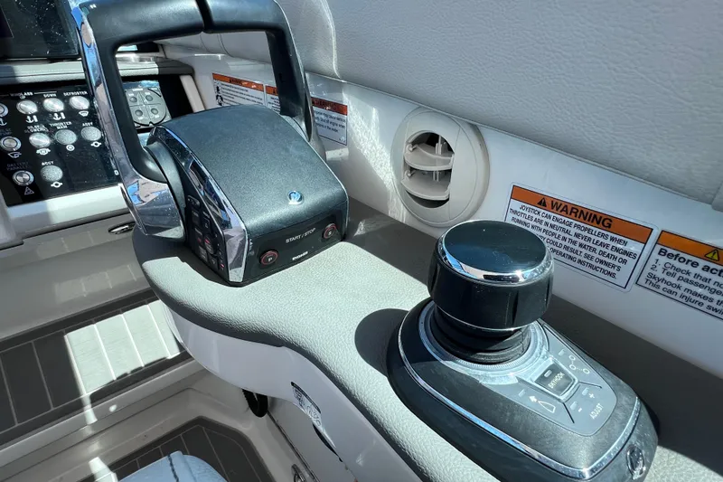 Slide: The Image of 2022 Sea Ray Sundancer 320 Coupe Outboard helm controls with joystick and throttle. - 25