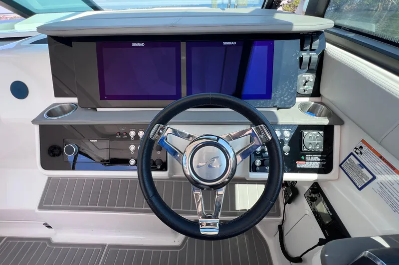 Slide: The Image of 2022 Sea Ray Sundancer 320 Coupe Outboard helm with dual Simrad displays and modern controls. - 28