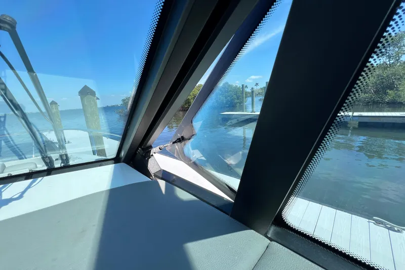 Slide: The Image of 2022 Sea Ray Sundancer 320 Coupe Outboard interior view with waterfront scenery. - 29