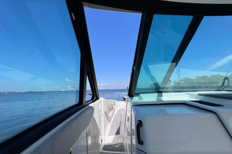 Slide: The Image of 2022 Sea Ray Sundancer 320 Coupe Outboard, view through windshield, on calm water. - 31