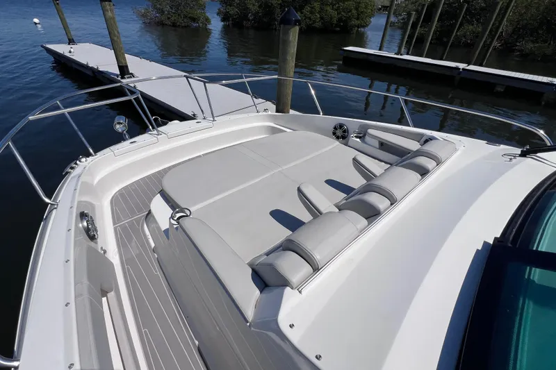 Slide: The Image of 2022 Sea Ray Sundancer 320 Coupe Outboard with spacious sun deck at marina. - 32