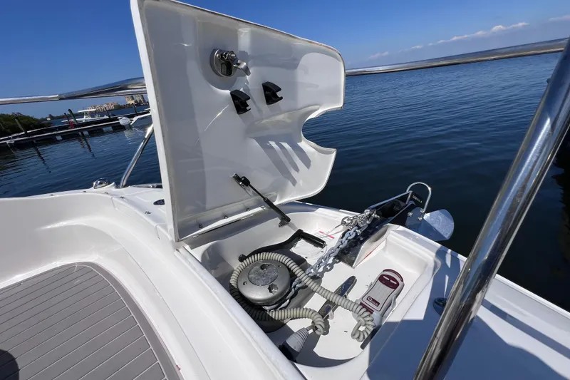 Slide: The Image of 2022 Sea Ray Sundancer 320 Coupe Outboard anchor compartment with open hatch, dockside view. - 34