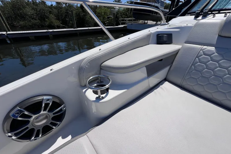 Slide: The Image of 2022 Sea Ray Sundancer 320 Coupe Outboard interior with speaker and cup holder detail. - 35