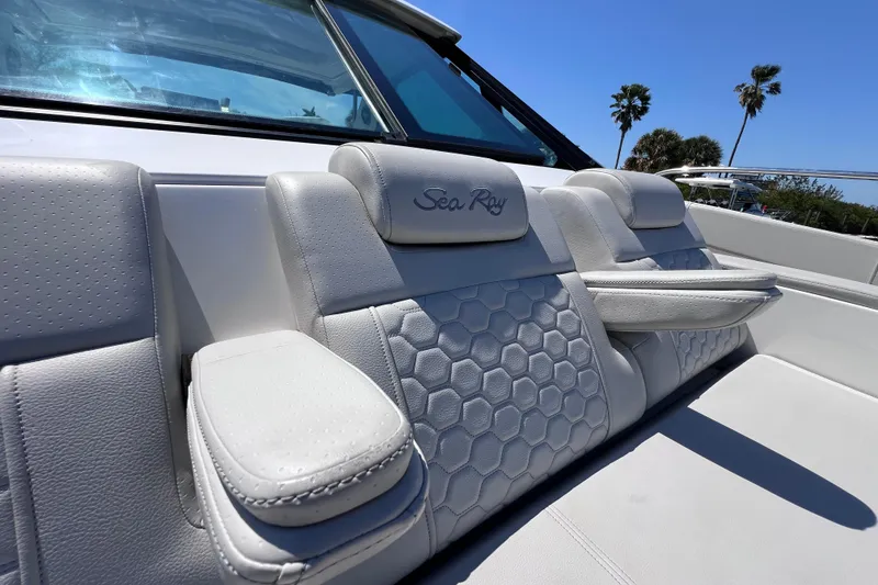 Slide: The Image of 2022 Sea Ray Sundancer 320 Coupe Outboard interior seating with hexagonal pattern and armrests. - 36
