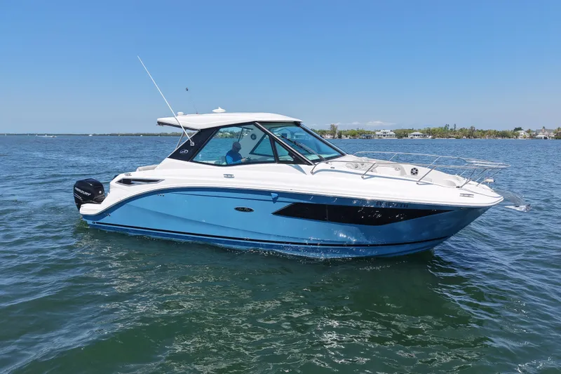 Slide: The Image of 2022 Sea Ray Sundancer 320 Coupe Outboard cruising on a sunny day. - 4