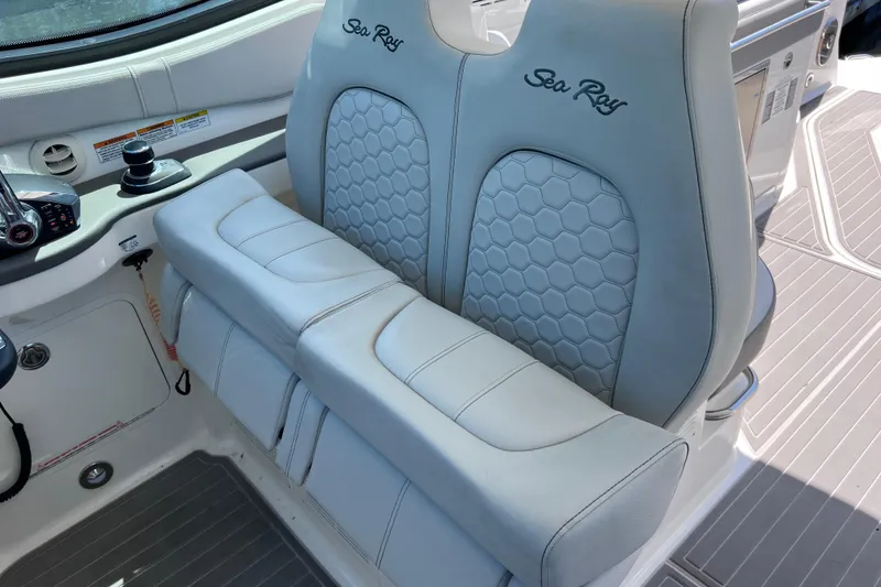 Slide: The Image of 2022 Sea Ray Sundancer 320 Coupe Outboard cockpit with luxurious seating and modern controls. - 41