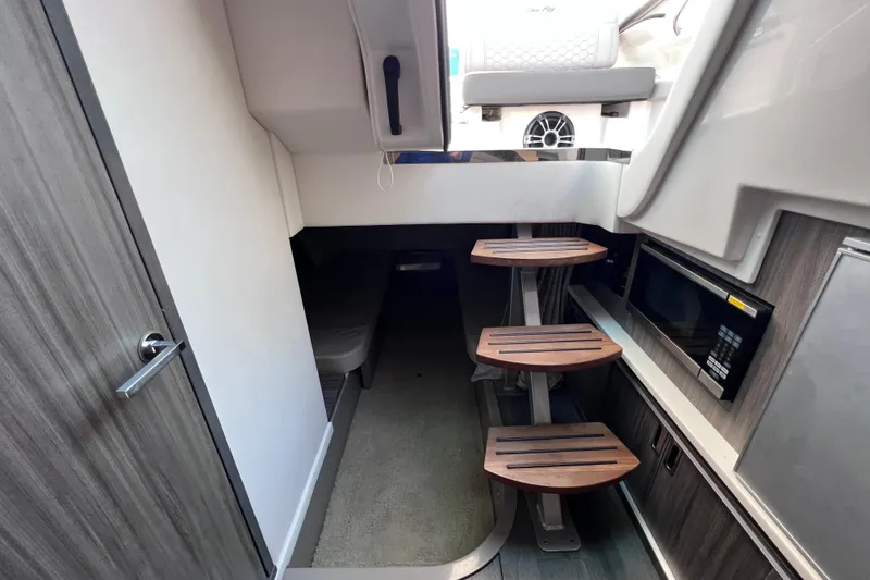 Slide: The Image of Interior of 2022 Sea Ray Sundancer 320 Coupe Outboard with wooden steps and modern amenities. - 45